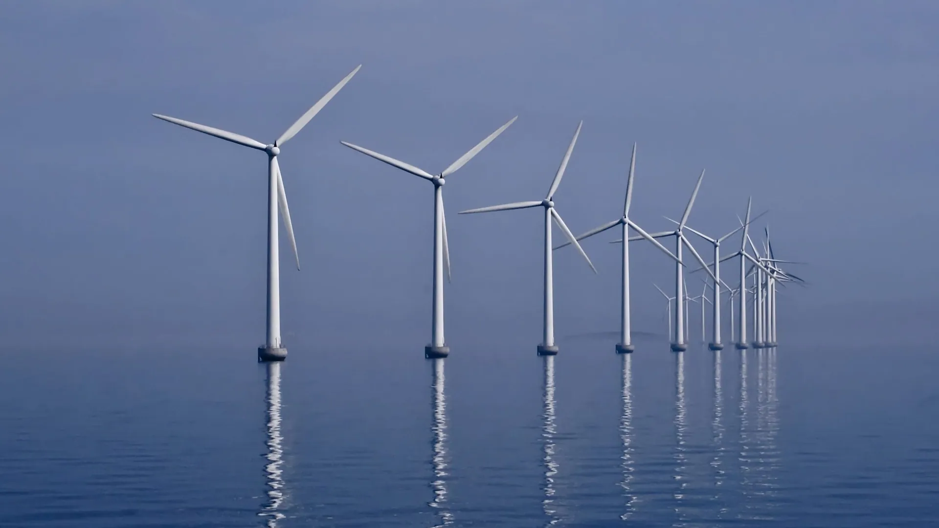 Offshore wind turbines standing in a calm sea