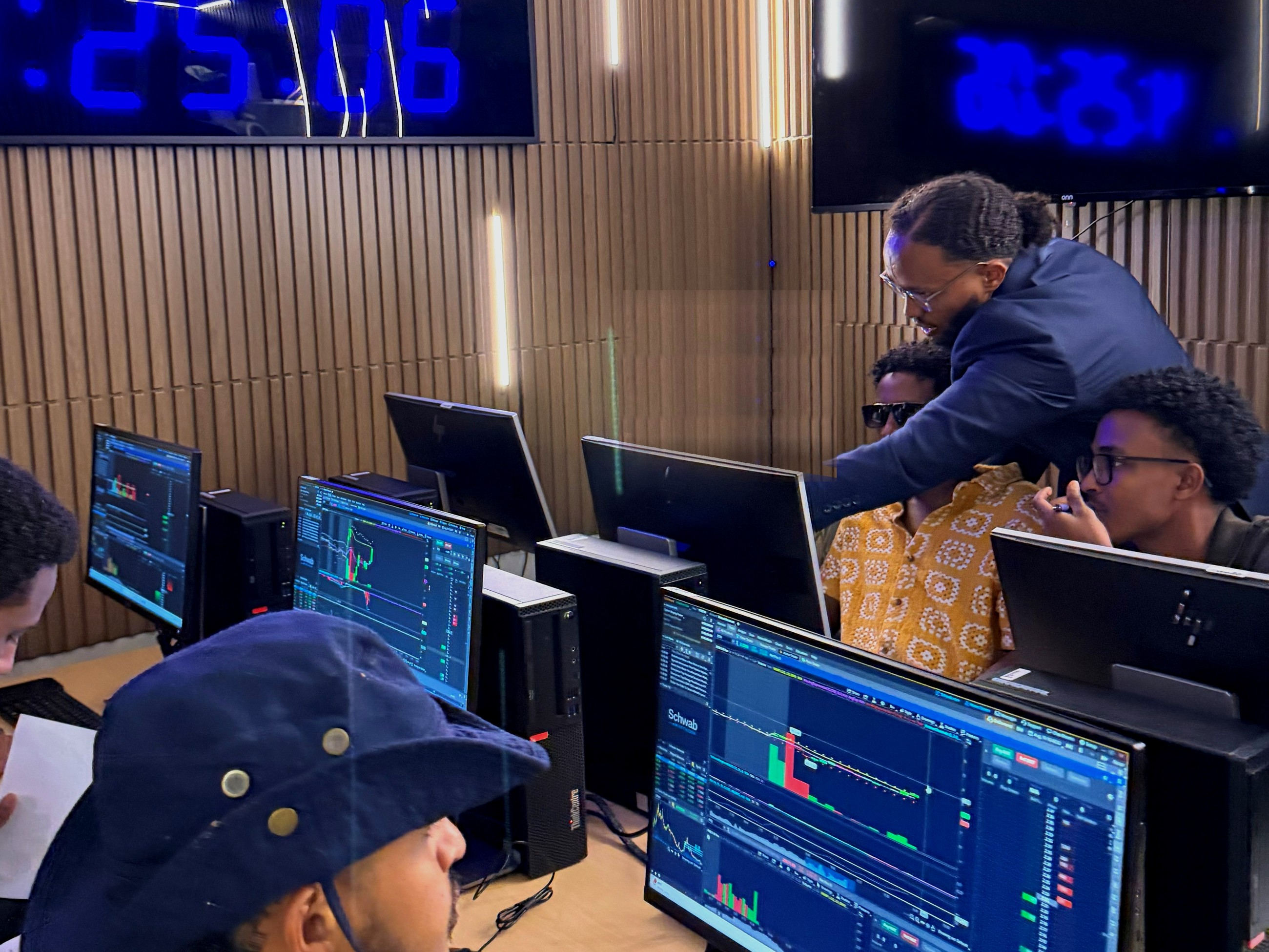 The instructor helping a student at a trading station at MAAL TRADING ACADEMY.